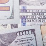 Detailed close-up of US dollar banknotes showcasing currency design and textures.