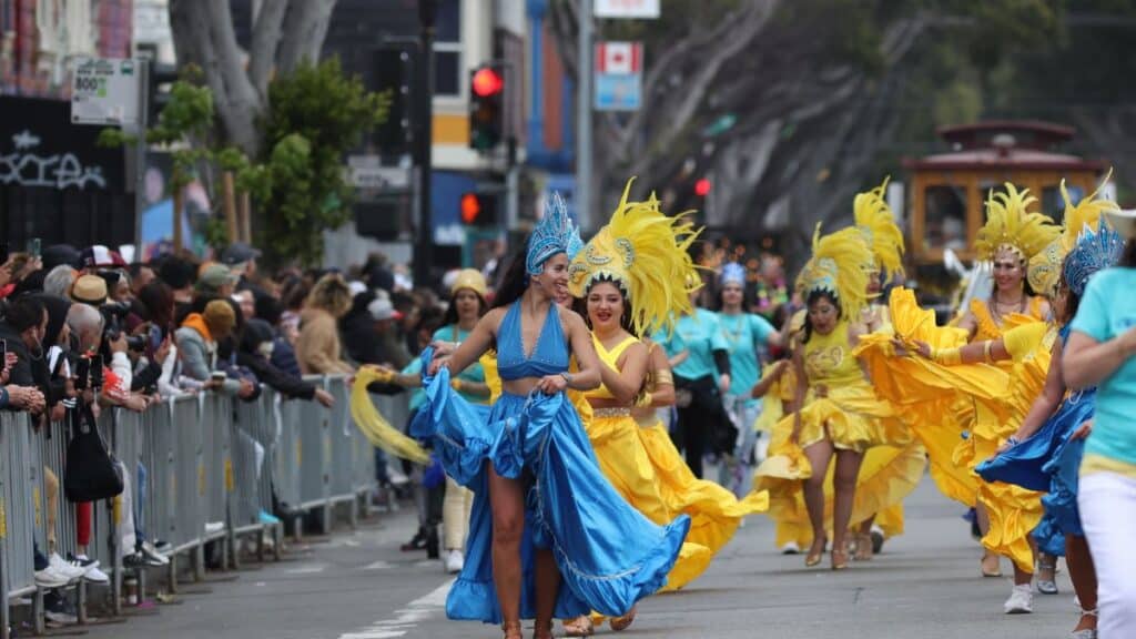 Colorful carnival dancers parade through the lively streets of San Francisco, California.