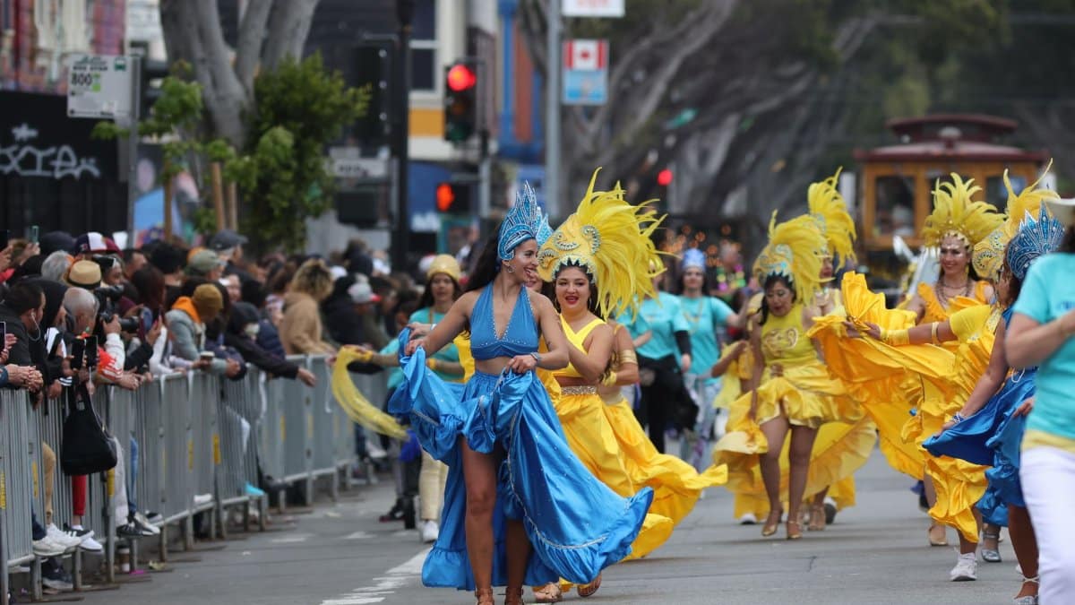 Colorful carnival dancers parade through the lively streets of San Francisco, California.