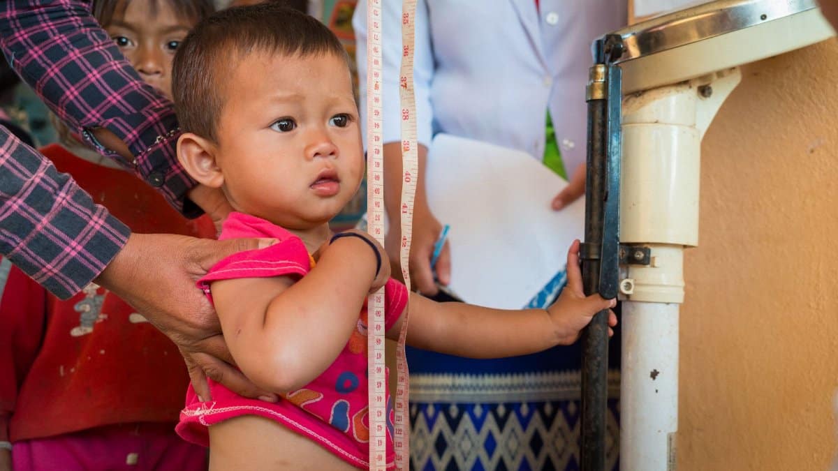 A child receives a health checkup in a rural Laos healthcare facility.