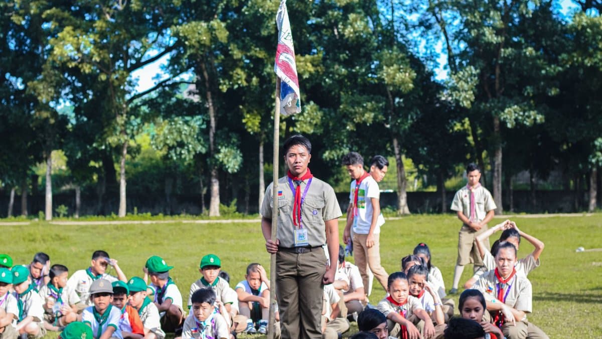 Boy Scouts gathered in a park, learning outdoor skills. Perfect for scouting and outdoor education themes.