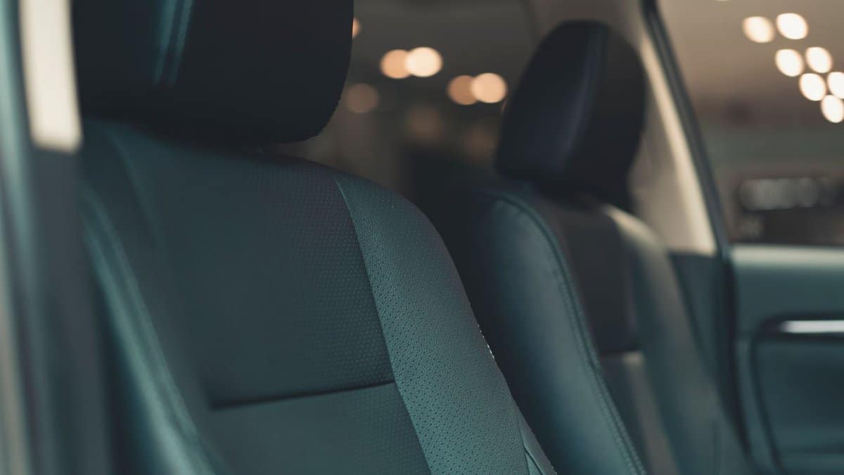 Close-up of a luxury car's leather seats with a soft focus background, showcasing premium comfort