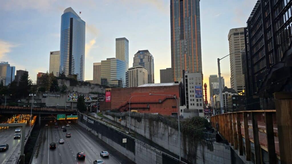 View of Seattle's urban skyline with busy highway below, captured during the day.