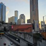 View of Seattle's urban skyline with busy highway below, captured during the day.