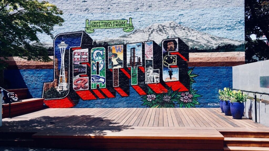 Vibrant mural showcasing Seattle's famous landmarks in a creative street art style.