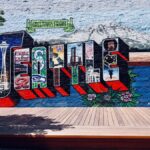 Vibrant mural showcasing Seattle's famous landmarks in a creative street art style.