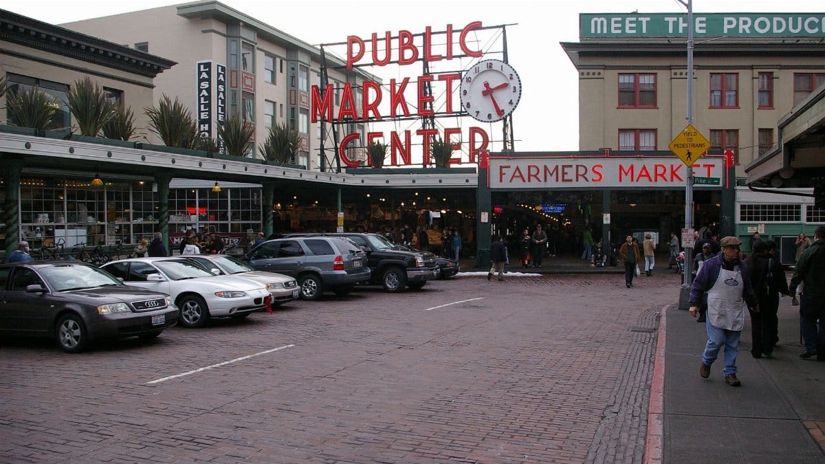 Historic Pike Place Market in Seattle with bustling activity and iconic signage.