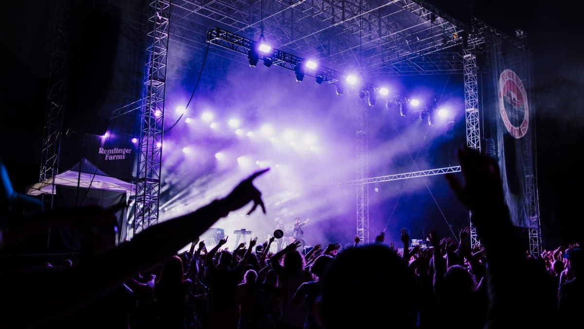 A vibrant concert scene in Seattle with an enthusiastic crowd under colorful lights.