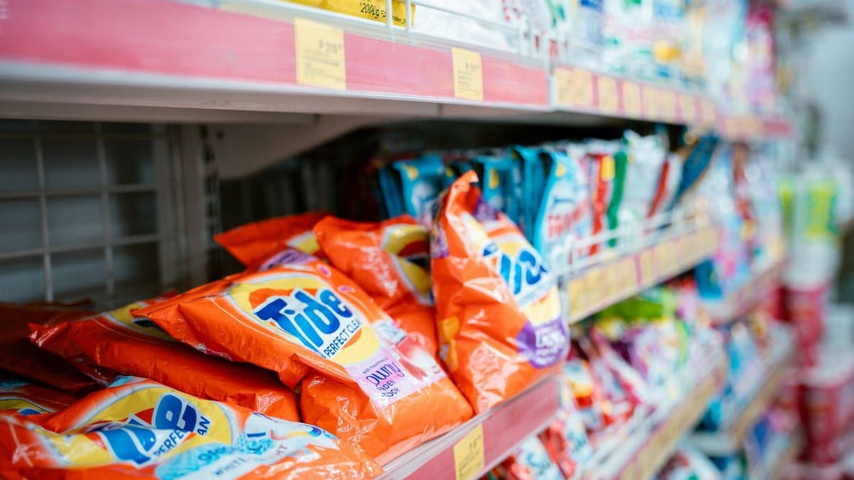 Vibrant selection of laundry detergents on a supermarket shelf, showcasing brands and variety.