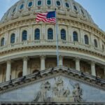 Close-up view of the iconic United States Capitol dome with American flag in Washington, D.C.