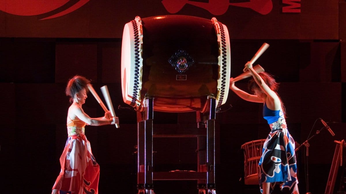 Intriguing taiko drummers in traditional attire deliver an energetic performance on stage.