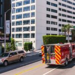 Los Angeles fire truck cruising down the famous Sunset Strip in daylight.