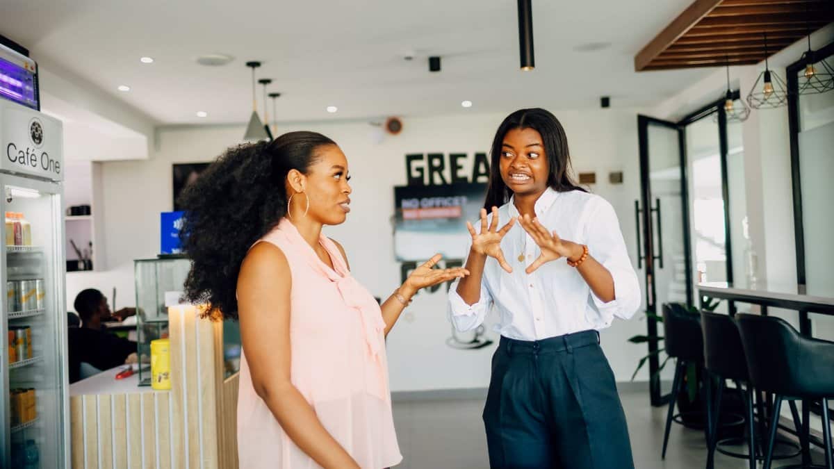 Two women engaging in a vibrant discussion at Café One in Lagos, Nigeria.