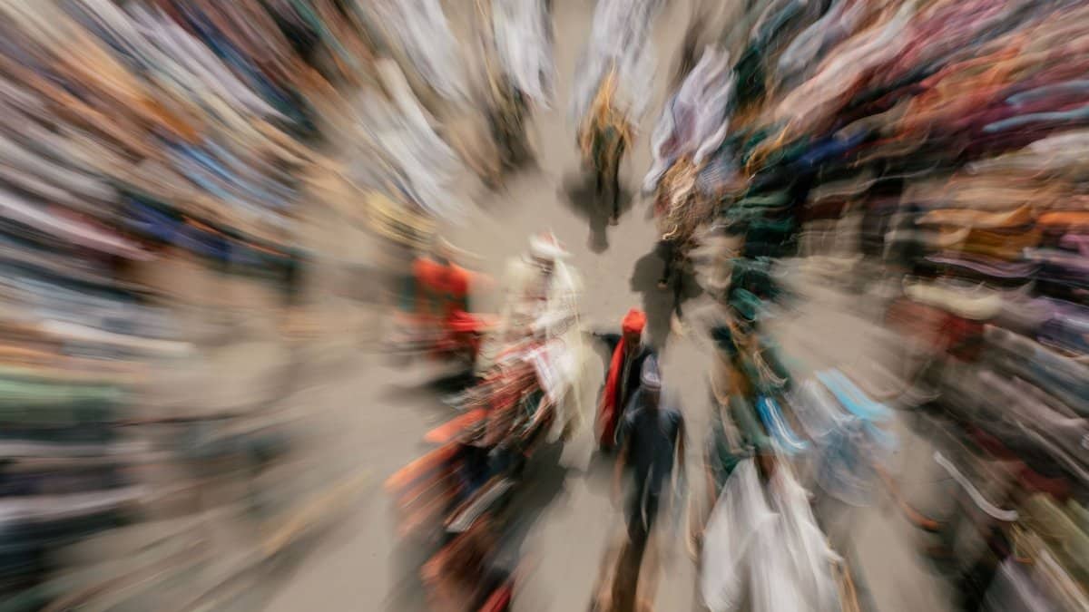 Zoom blur effect capturing a diverse crowd at an outdoor event, creating a sense of motion and energy.