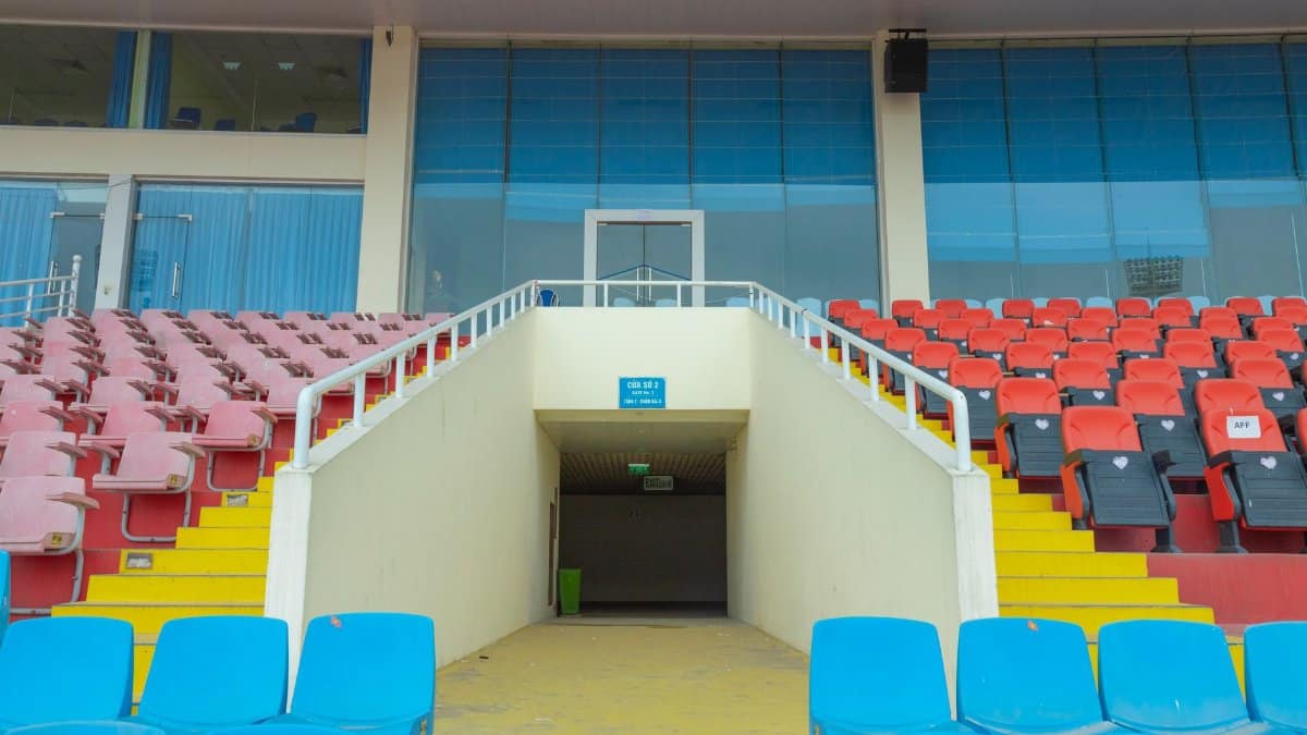 Vibrant stadium seats arranged in an empty arena highlighting architecture.