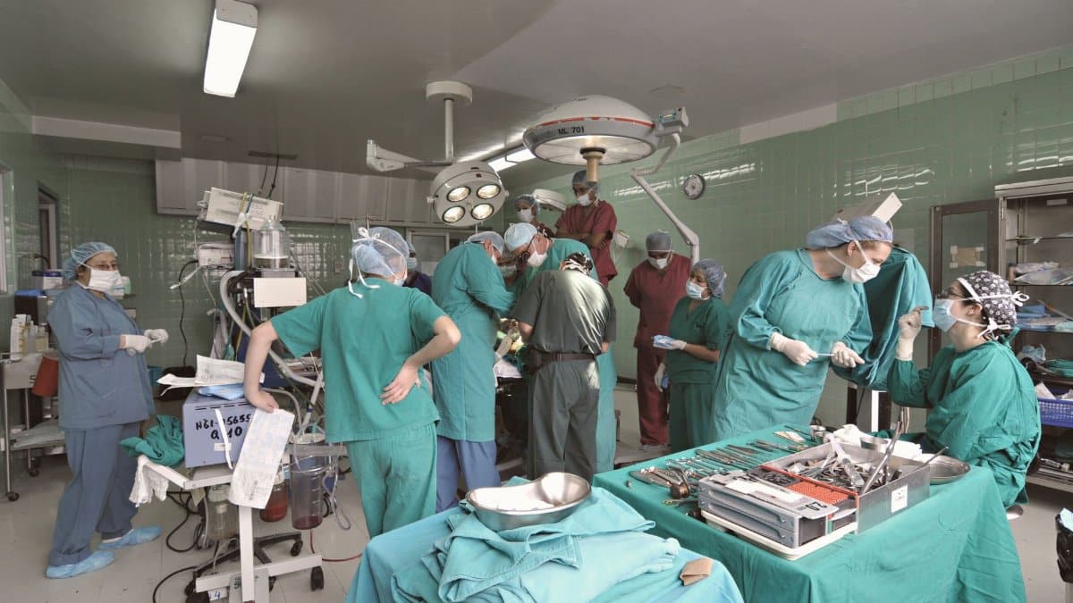 Surgeons and medical staff working together in a hospital operating room during surgery.
