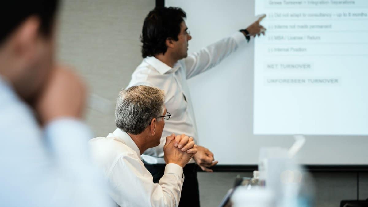Professional setting with team members focused on a business presentation. Ideal for corporate themes.
