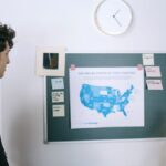 Young professionals discussing a map of US tech startups in a modern office setting.