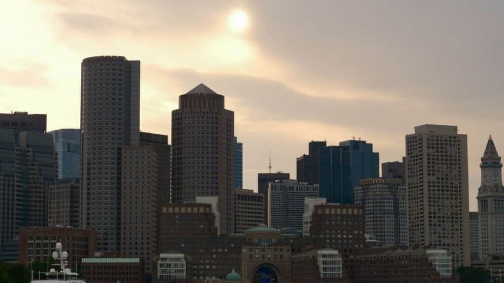 Scenic view of Boston's skyline and harbor at dusk with a calming atmosphere.