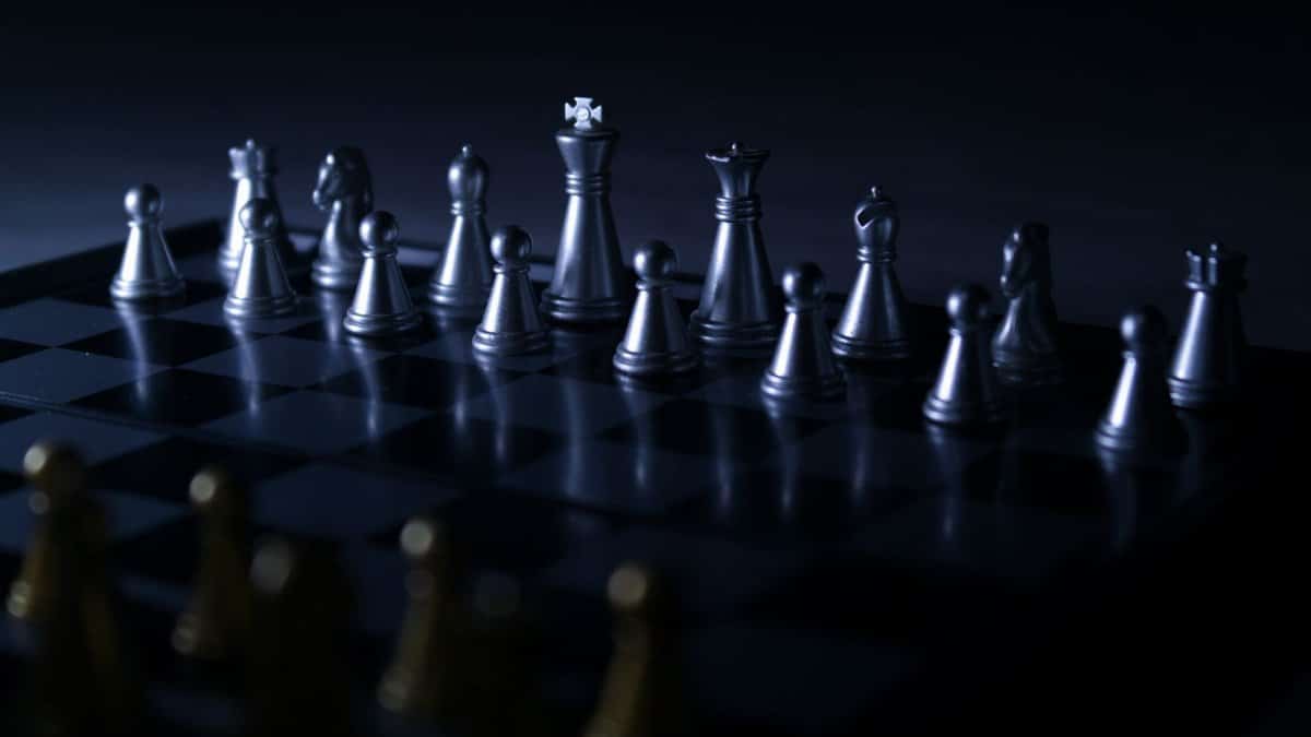 Moody chess set with dramatic lighting, highlighting strategic gameplay focus.