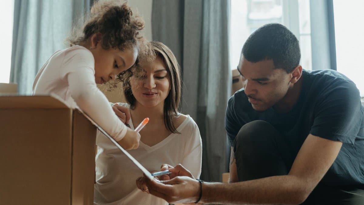 A family bonding over a creative drawing session while unpacking in their new home.