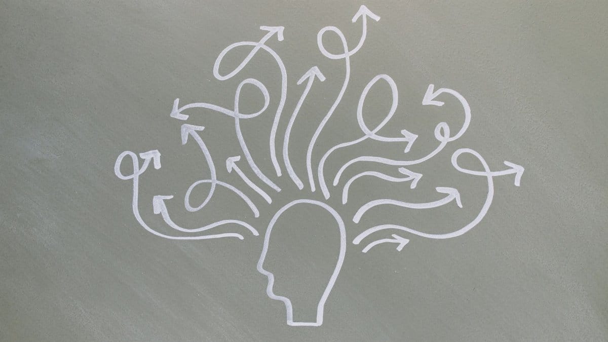 Conceptual chalk drawing illustrating mental health challenges with arrows representing thoughts.