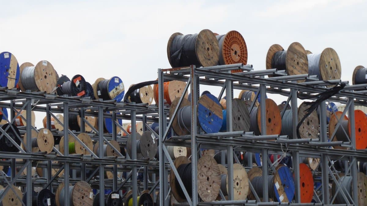 Colorful industrial cable reels stacked outdoors in Alphen aan den Rijn.