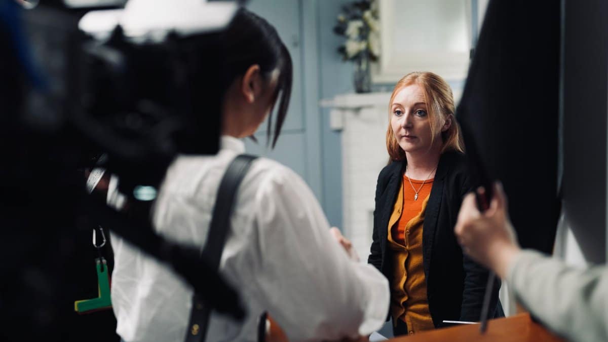 A behind-the-scenes look at a fashion shoot with women in conversation.