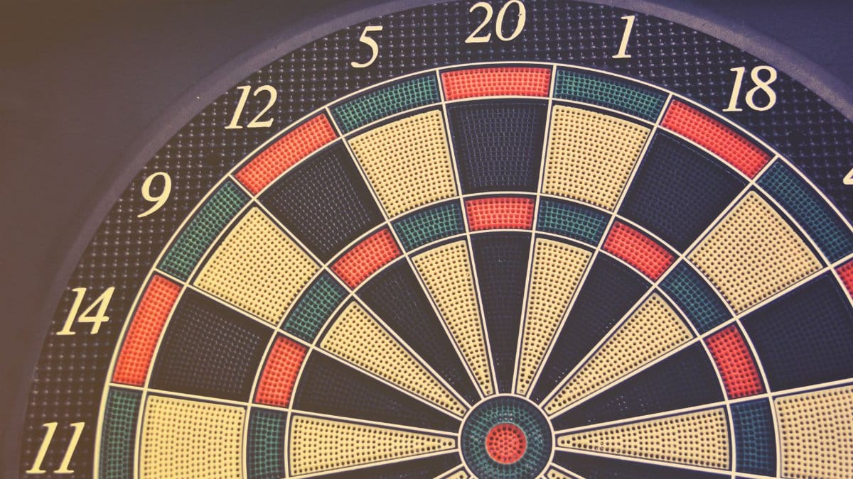 Close-up of a dartboard displaying numbers and colored segments, perfect for themes of accuracy and games.