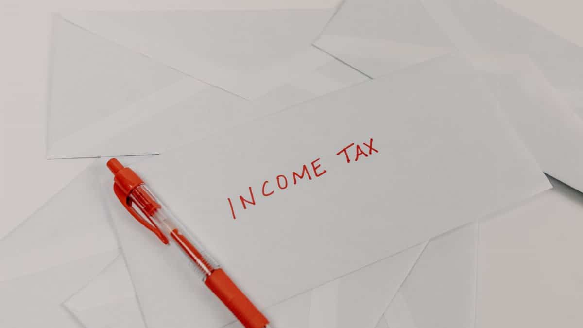 Studio shot of income tax envelope with red pen for accounting and tax season preparation.