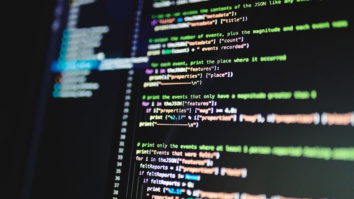 Close-up of colorful programming code displayed on a computer monitor with a dark background.