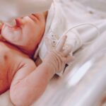 A newborn baby in a hospital setting receiving care with a focus on wellness and health.