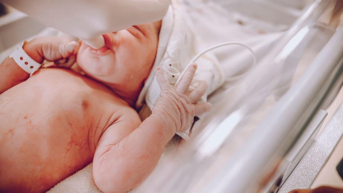 A newborn baby in a hospital setting receiving care with a focus on wellness and health.