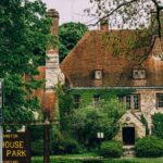 Charming stone house with ivy-covered walls in a lush garden at Lighthouse Landing Park, Evanston.