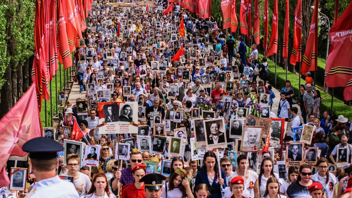 Crowd marching with photos of ancestors on Victory Day in Volgograd, Russia