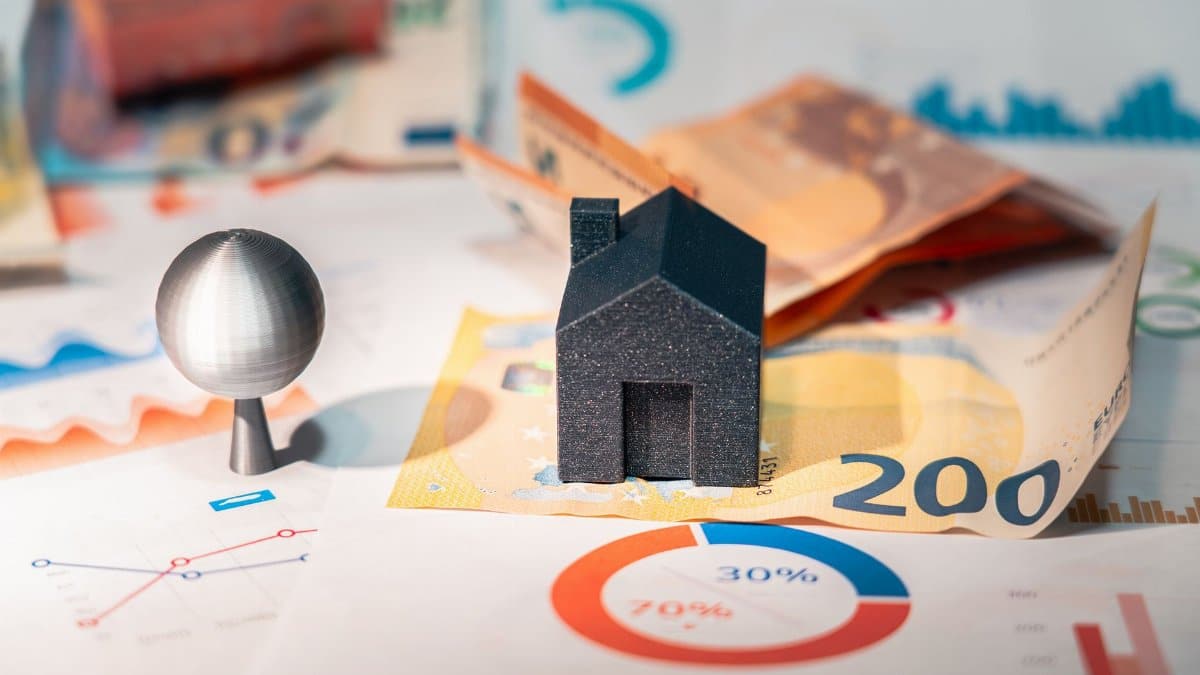 Conceptual image of real estate and finance involving euro currency and data charts, symbolizing investment.