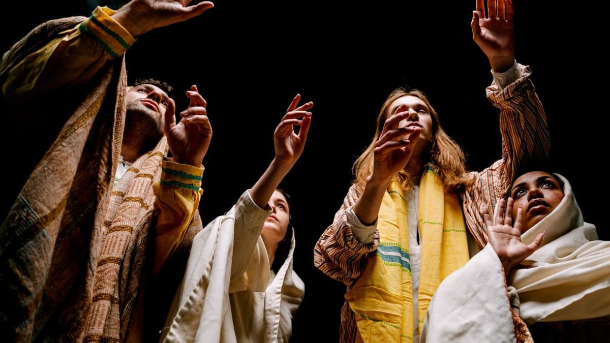 A theatrical performance capturing actors in expressive poses wearing ethnic costumes.