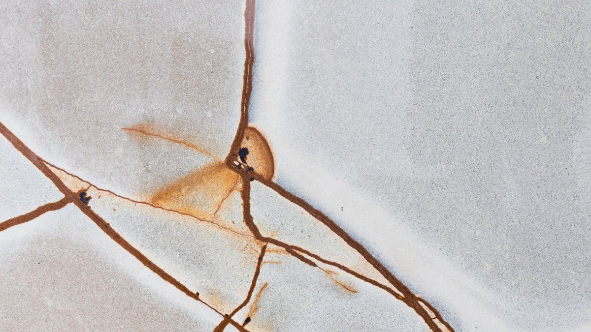 Detailed macro shot of a cracked and textured surface with unique rust patterns.