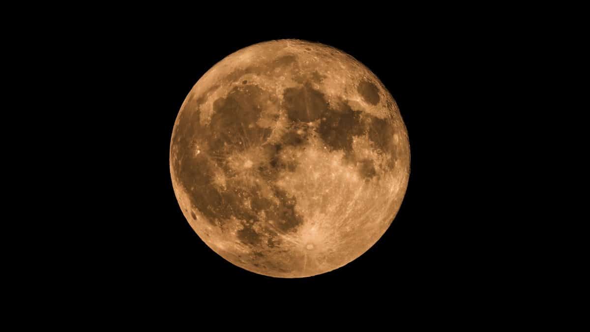 High-resolution image of a glowing full moon in a dark night sky, capturing lunar details.