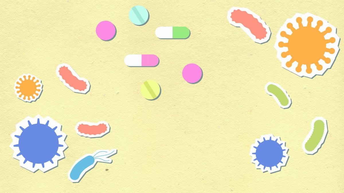Paper cutout of colorful contagious types of viruses on yellow background with pills and capsules for treatment during disease care routine