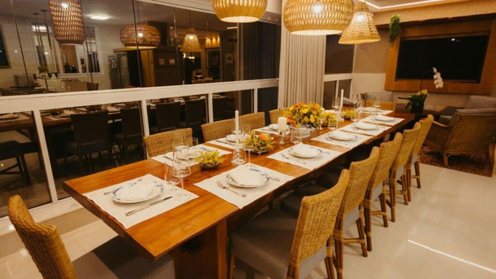 Warm and inviting dining room with wooden table, woven chairs, and ambient lighting, ready for a formal dinner.