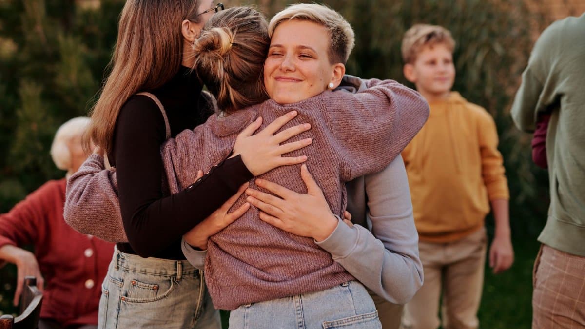A touching moment of a family reunion with members happily embracing outdoors.
