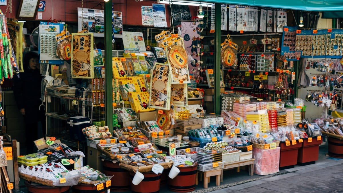 Vibrant outdoor storefront in Hachioji, Tokyo showcasing traditional Japanese souvenirs and goods.