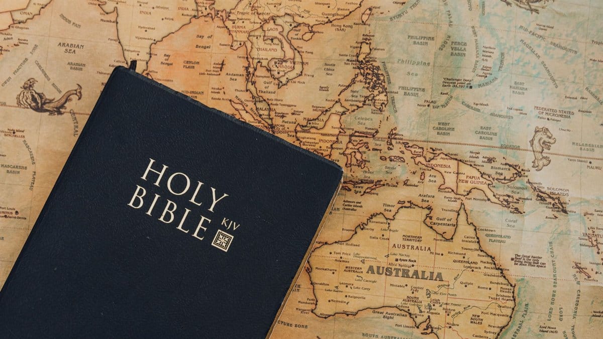 A King James Version Bible placed on a vintage-style world map.