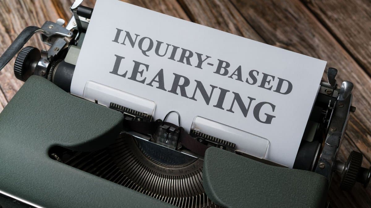 Close-up of a typewriter with paper showing 'INQUIRY-BASED LEARNING'.
