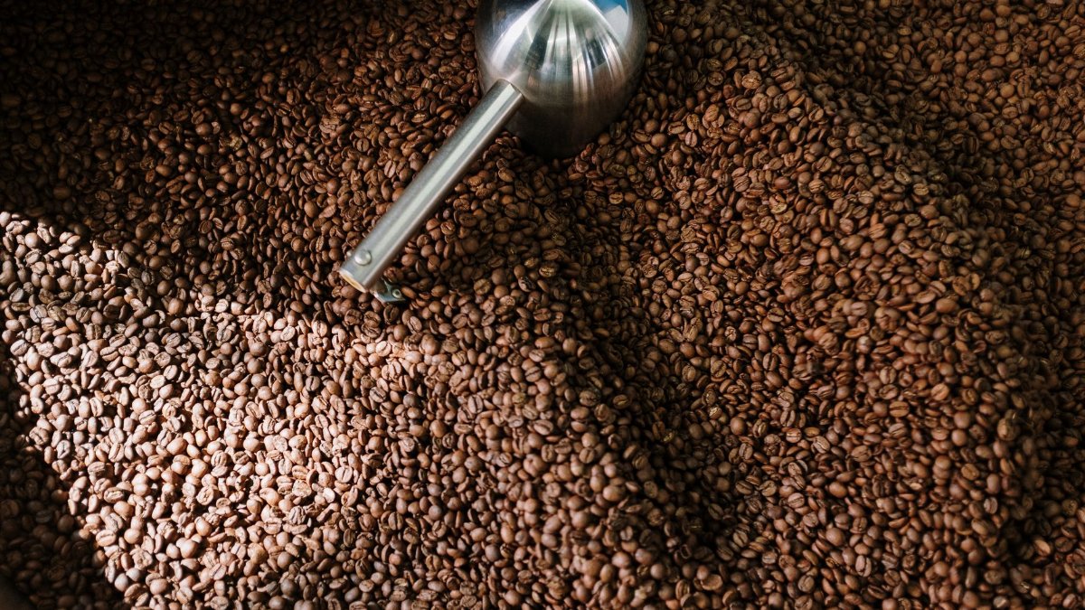 Detailed image of roasted coffee beans spinning inside a professional coffee roaster.