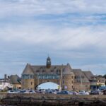 Charming coastal view of The Towers amid serene blue skies in New Shoreham, Rhode Island.