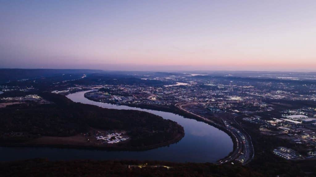 Stunning aerial view of Chattanooga, Tennessee at twilight showcasing the city and surrounding river.