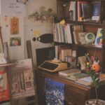 A warm, cluttered study filled with books, a typewriter, and vintage decor creating a cozy ambiance.