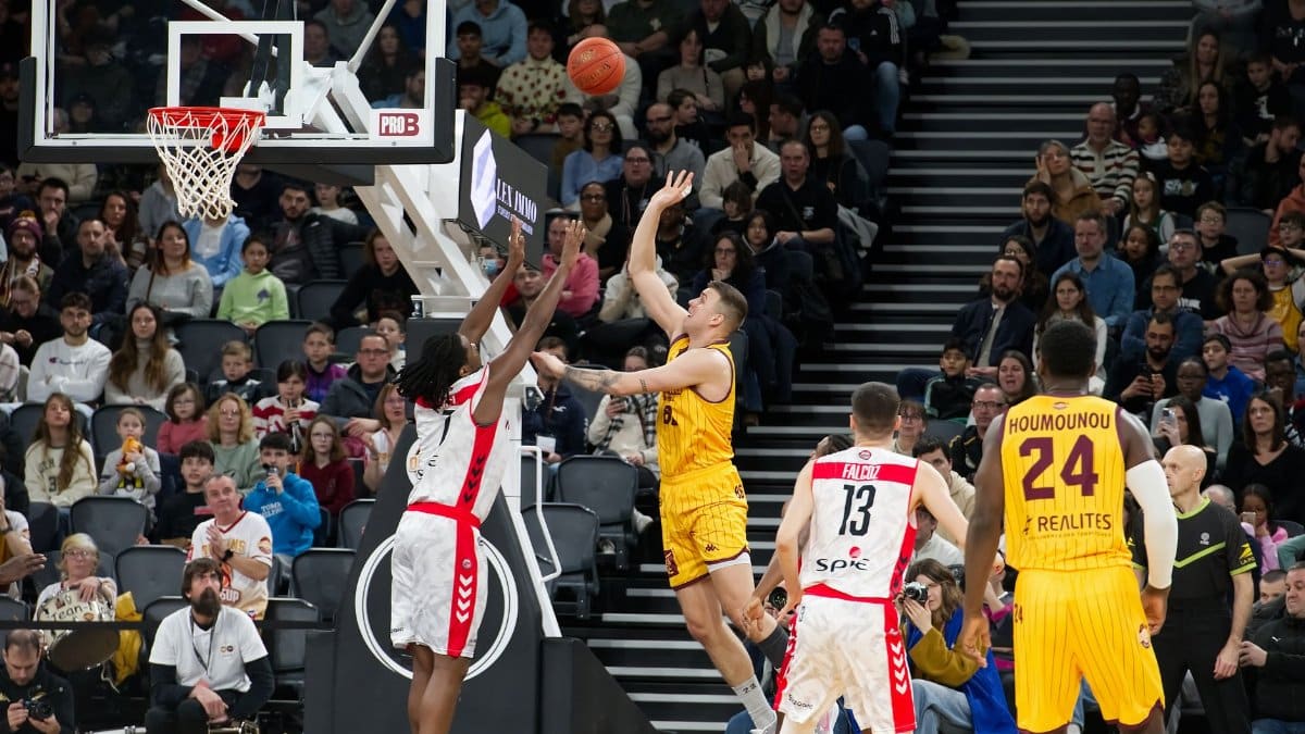 Dramatic moment in a basketball game with players and an engaged crowd.